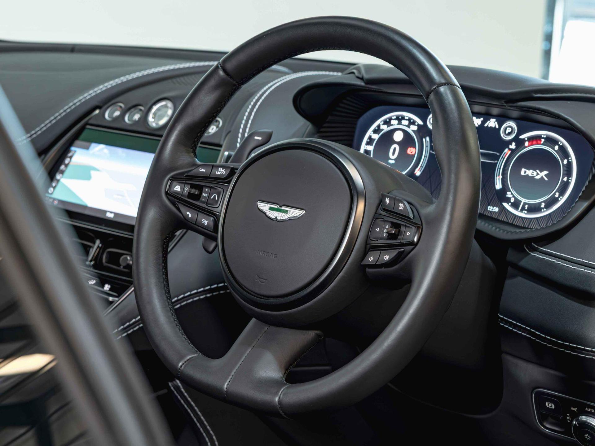 An interior shot of the steering wheel on a 2022 Aston Martin DBX