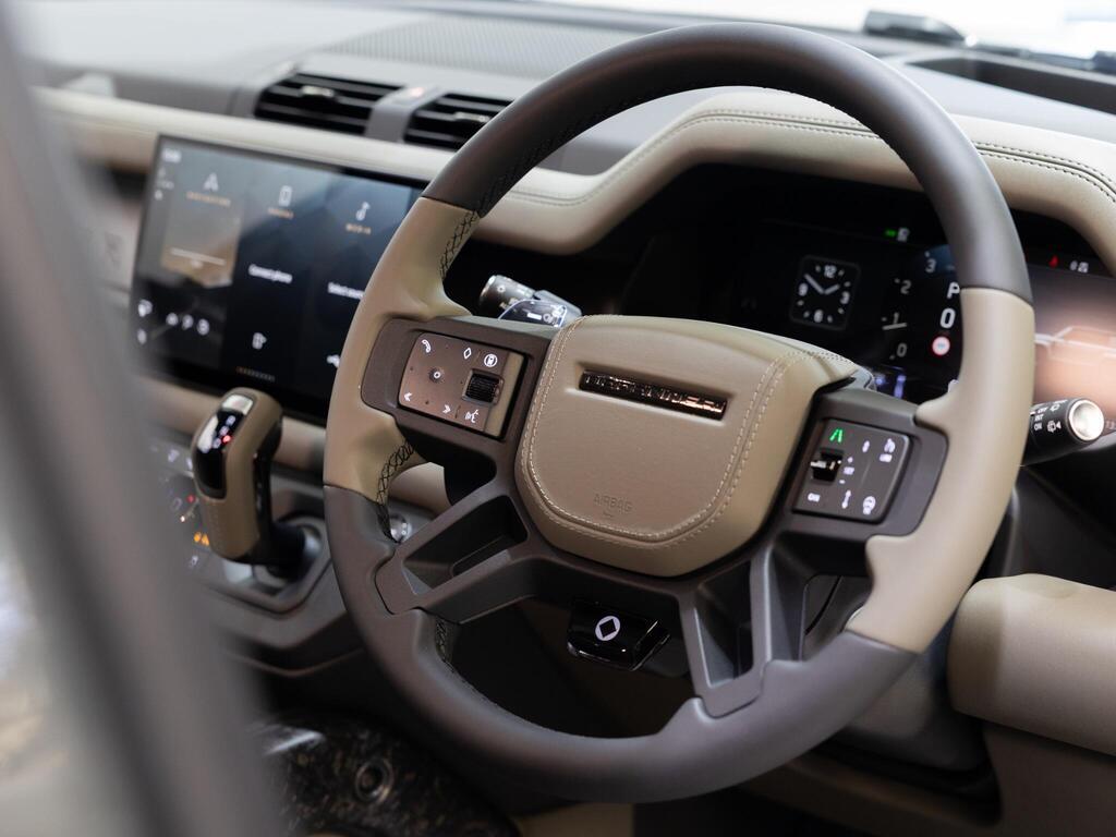 An interior shot of the steering wheel on a 2026 Land Rover Defender 110