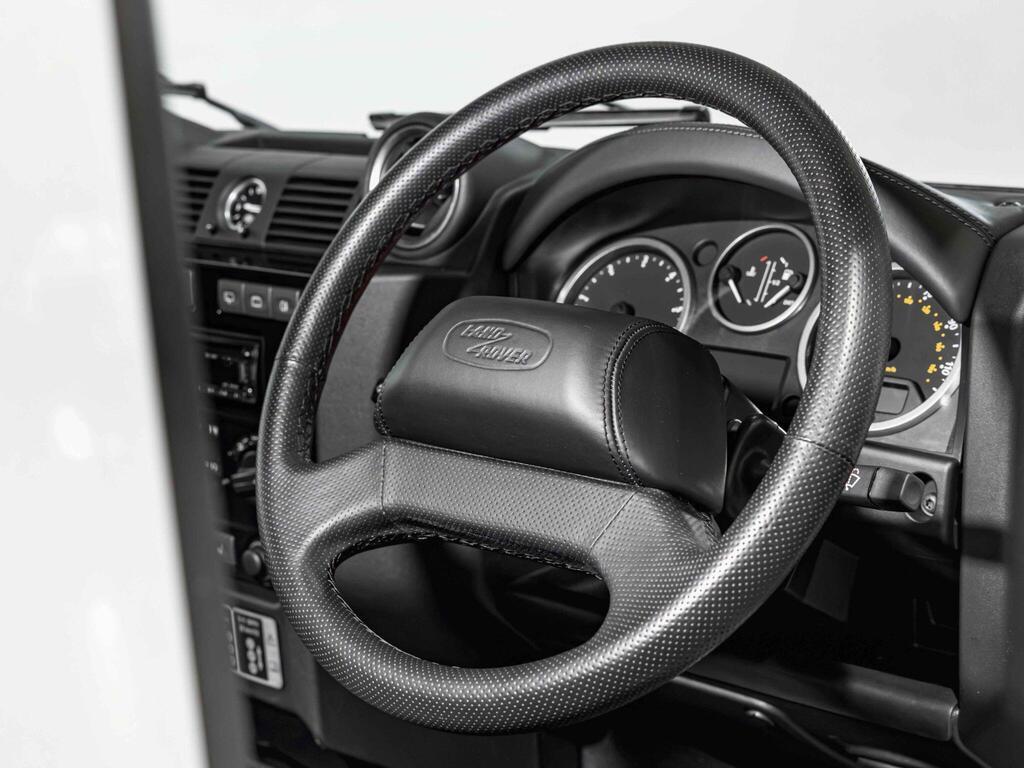 An interior shot of the steering wheel on a 2016 Land Rover Defender 90