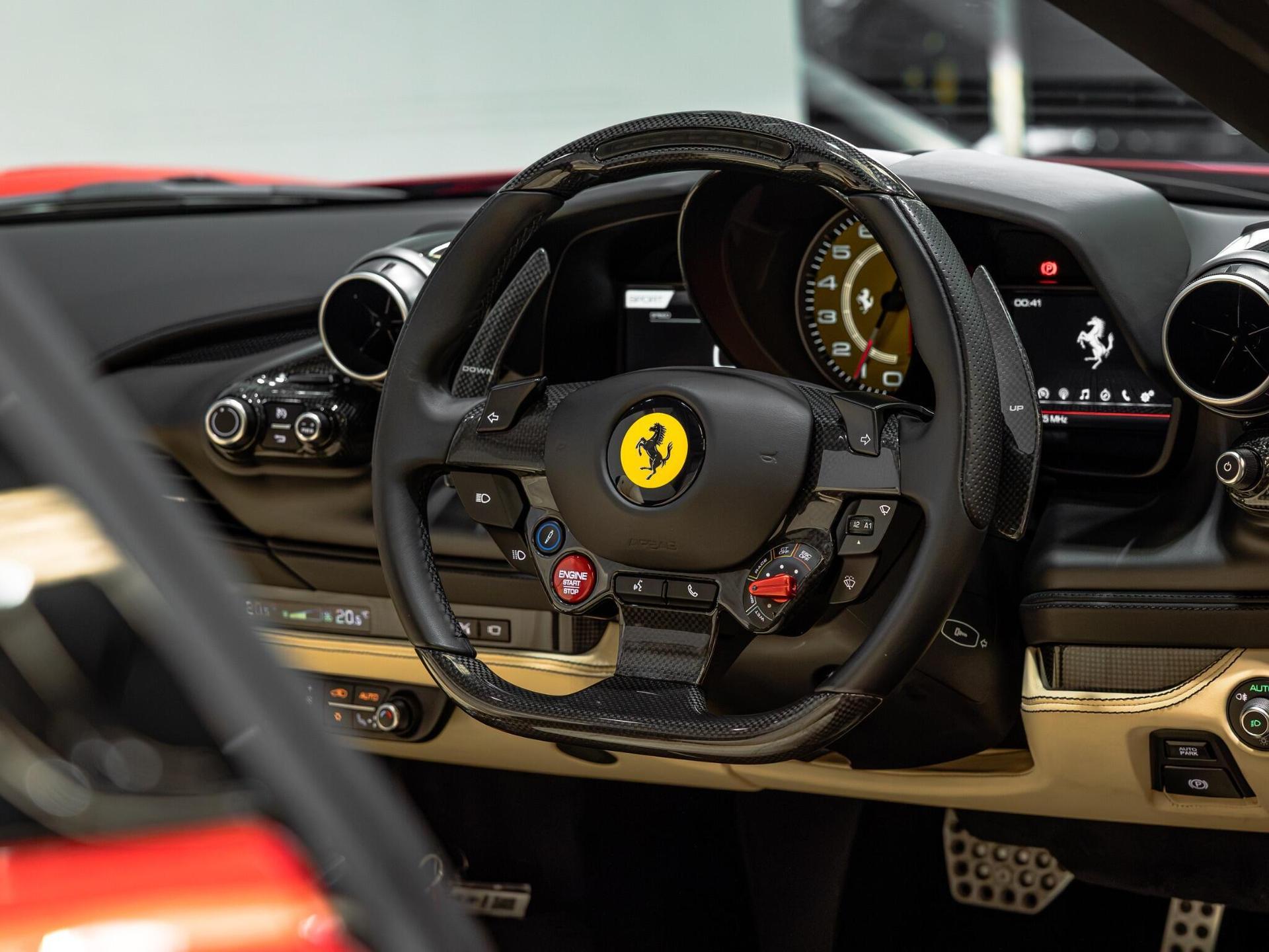 An interior shot of the steering wheel on a 2021 Ferrari F8 Spider