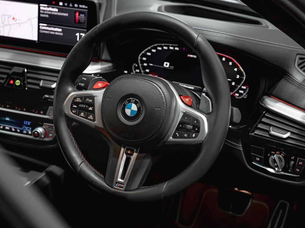 An interior shot of the steering wheel on a 2021 BMW M5