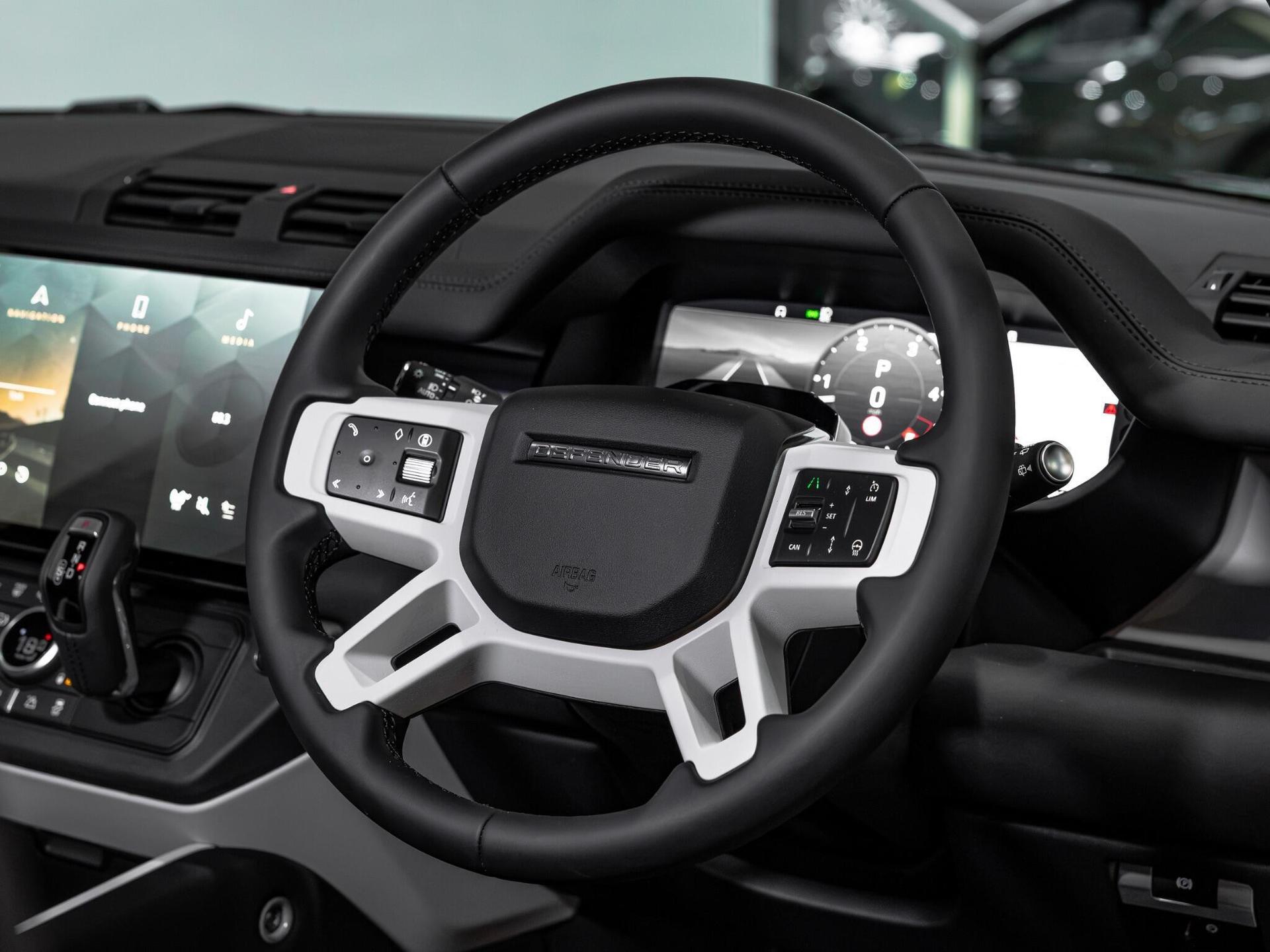 An interior shot of the steering wheel on a 2026 Land Rover Defender 90