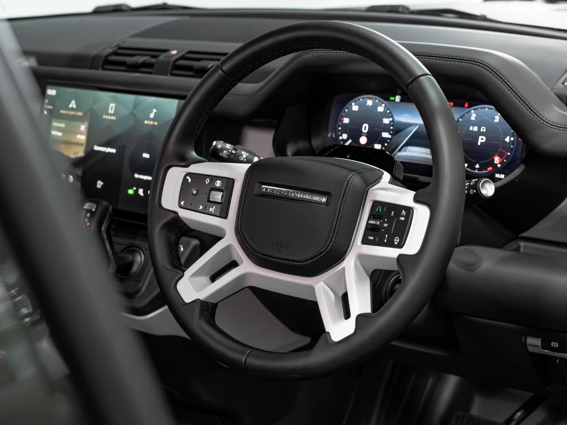 An interior shot of the steering wheel on a 2026 Land Rover Defender 110