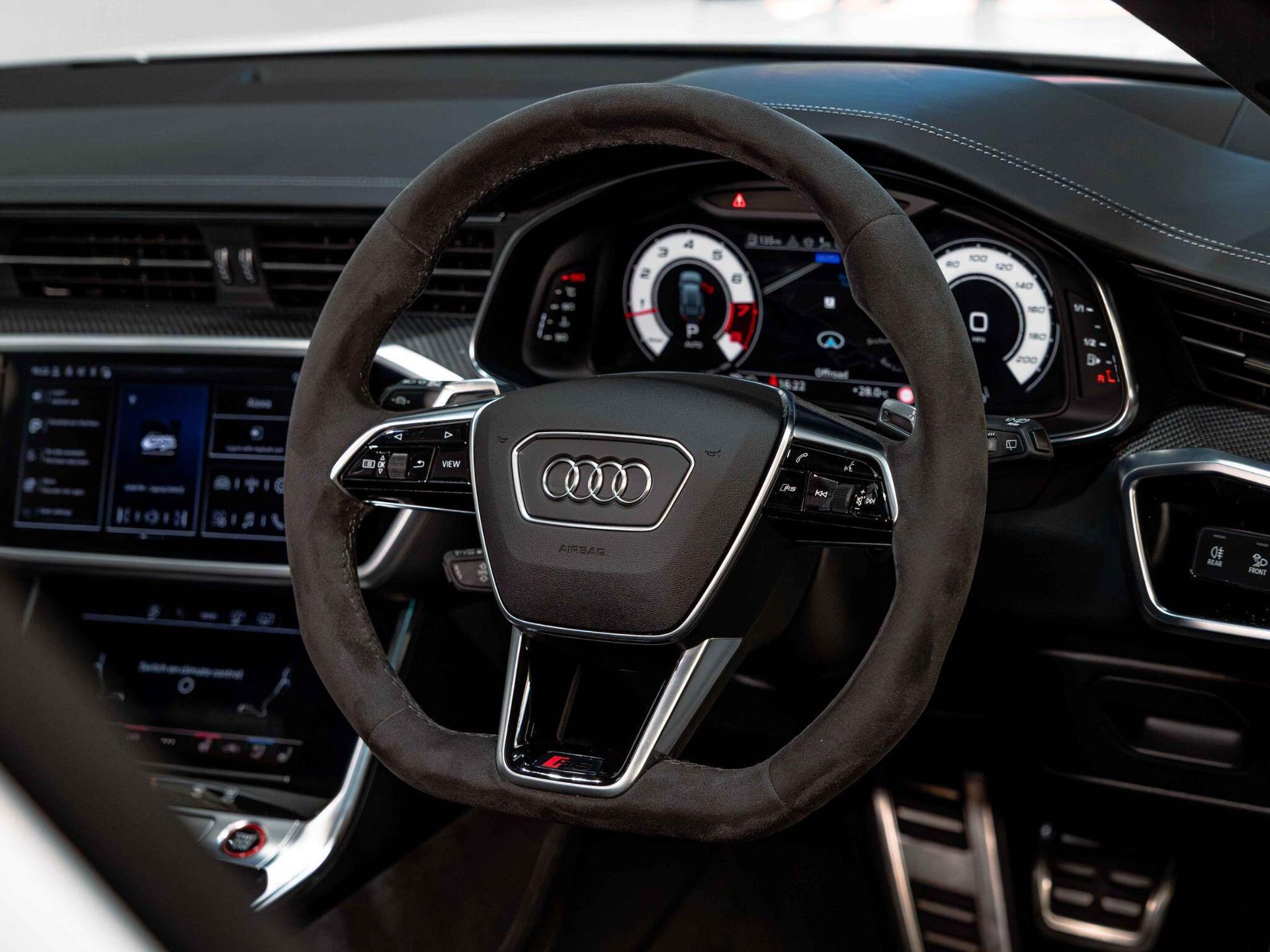 An interior shot of the steering wheel on a 2024 Audi RS6 Avant