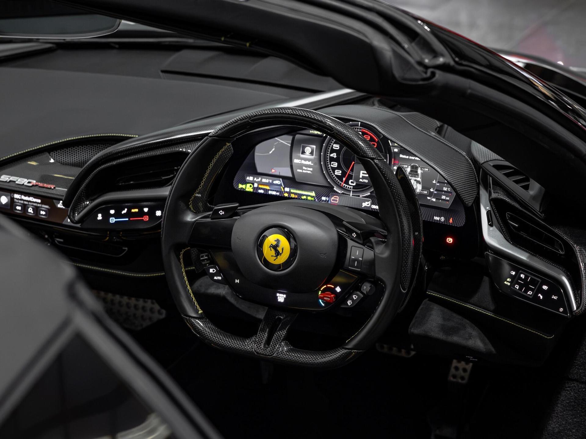An interior shot of the steering wheel on a 2023 Ferrari SF90 Spider