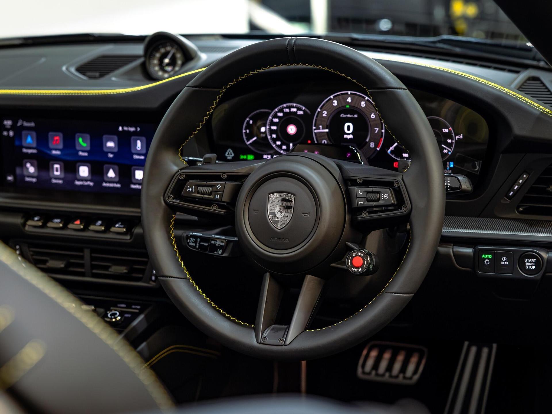 An interior shot of the steering wheel on a 2026 Porsche 911