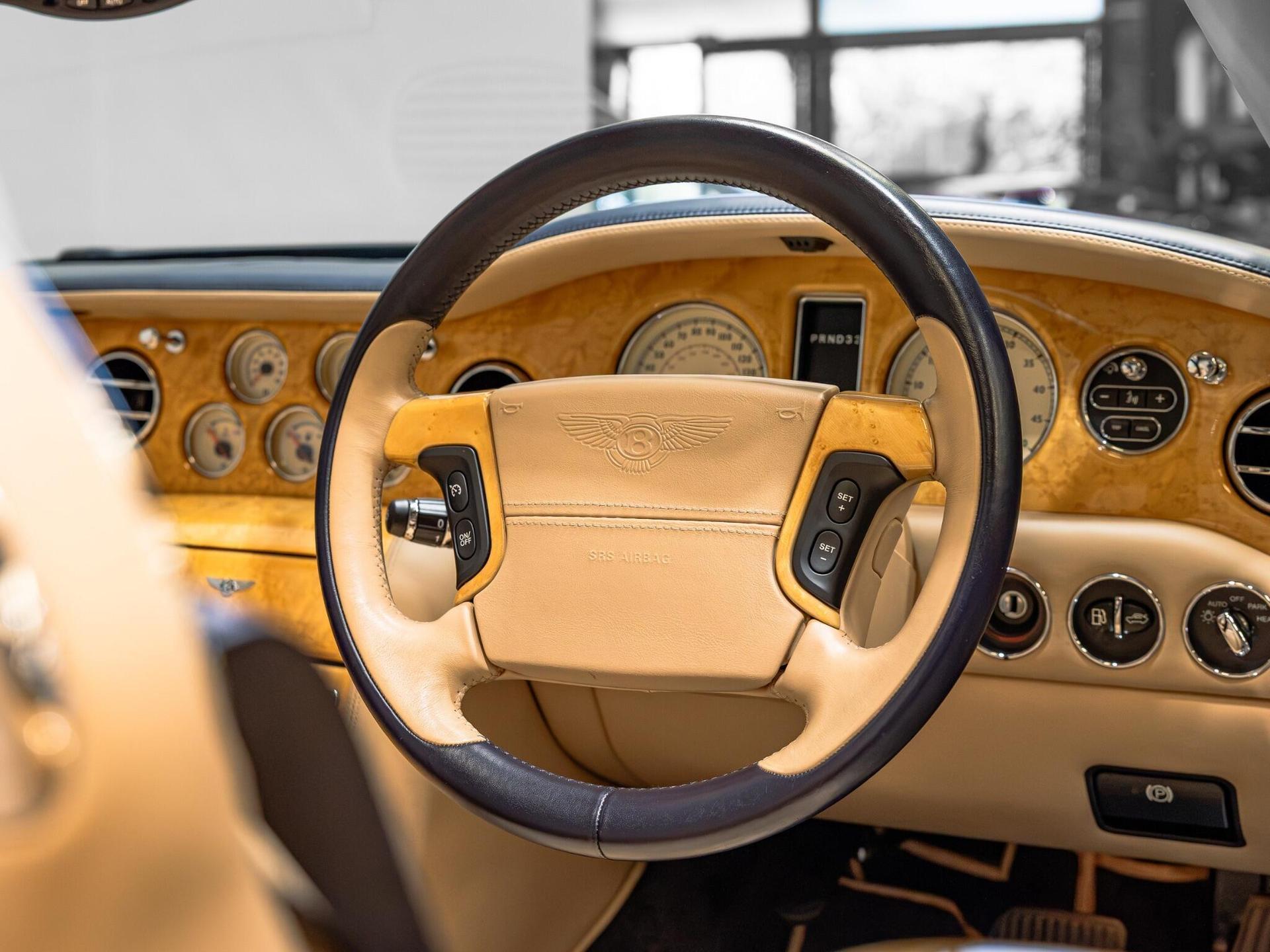 An interior shot of the steering wheel on a 2006 Bentley Azure