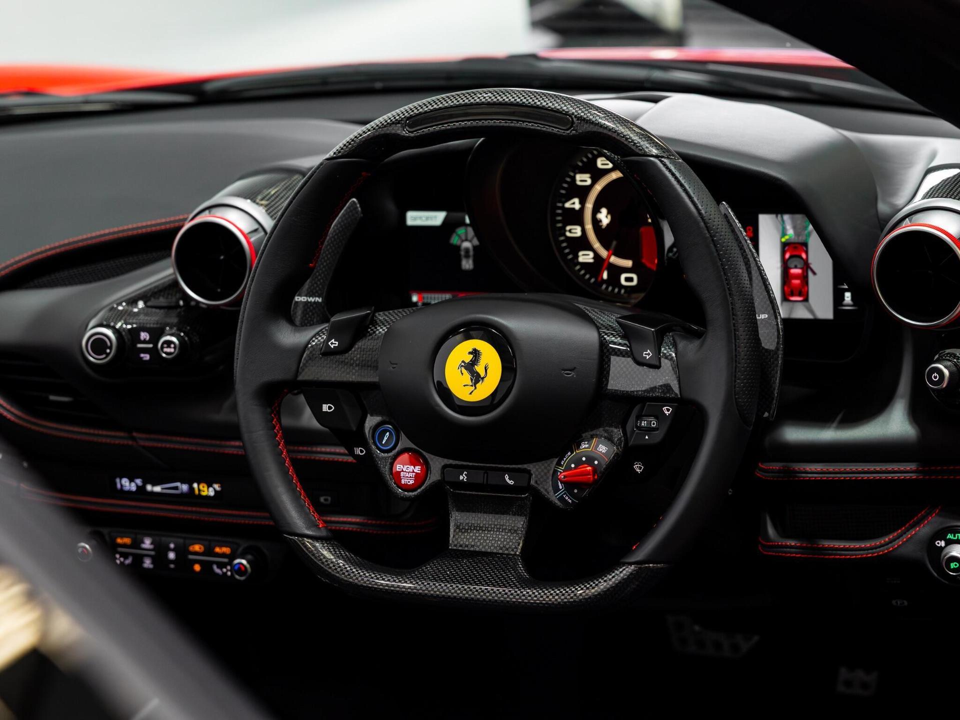 An interior shot of the steering wheel on a 2022 Ferrari F8 Spider
