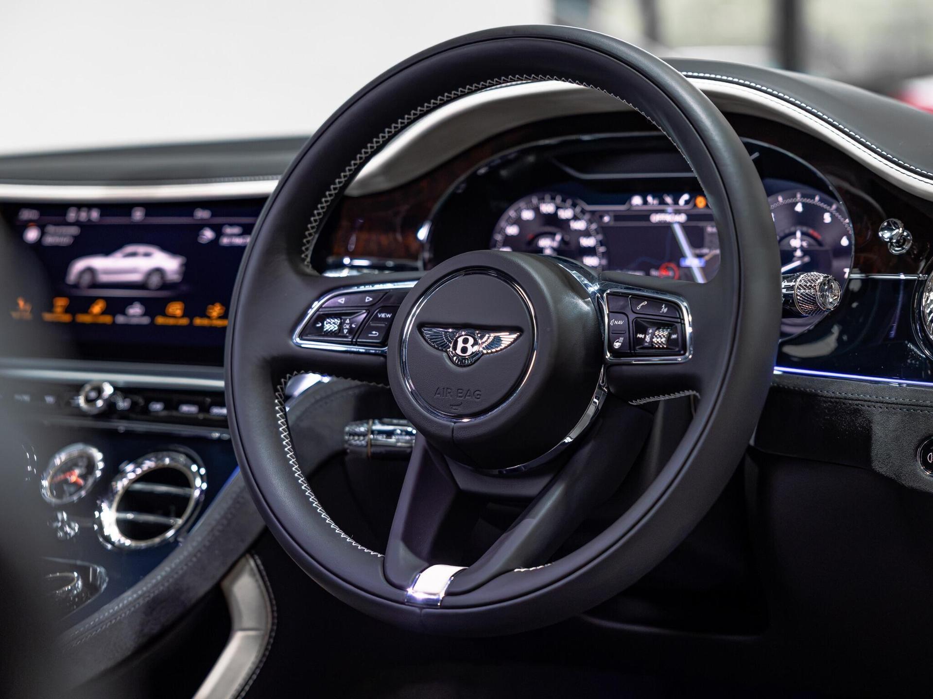An interior shot of the steering wheel on a 2021 Bentley Continental