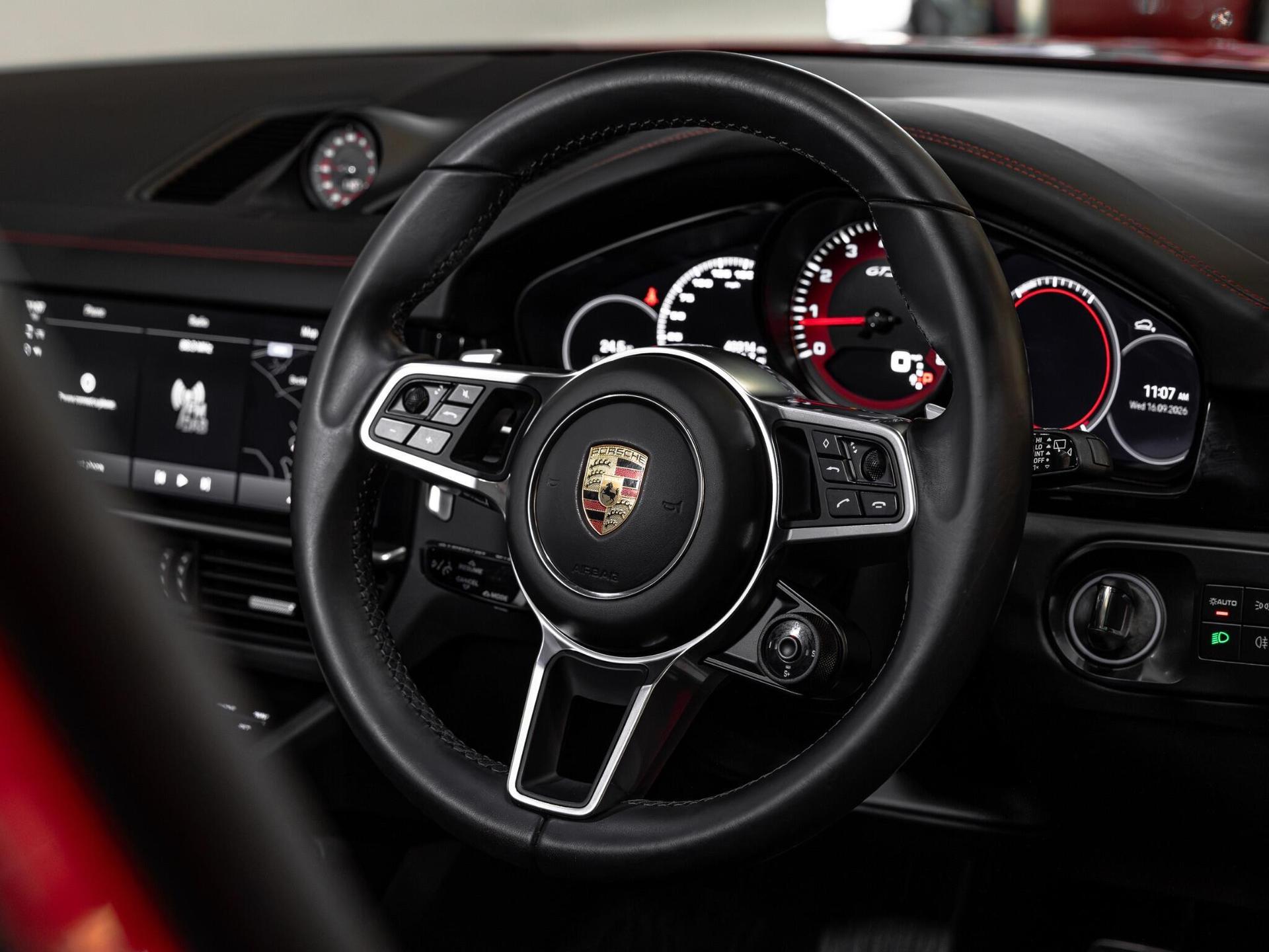 An interior shot of the steering wheel on a 2021 Porsche Cayenne
