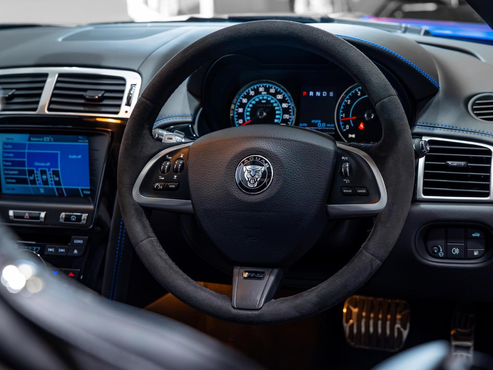 An interior shot of the steering wheel on a 2014 Jaguar XKR-S
