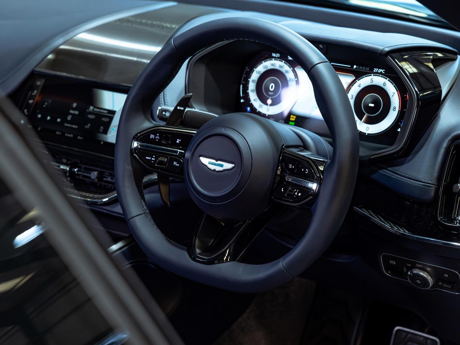 An interior shot of the steering wheel on a 2025 Aston Martin DBX