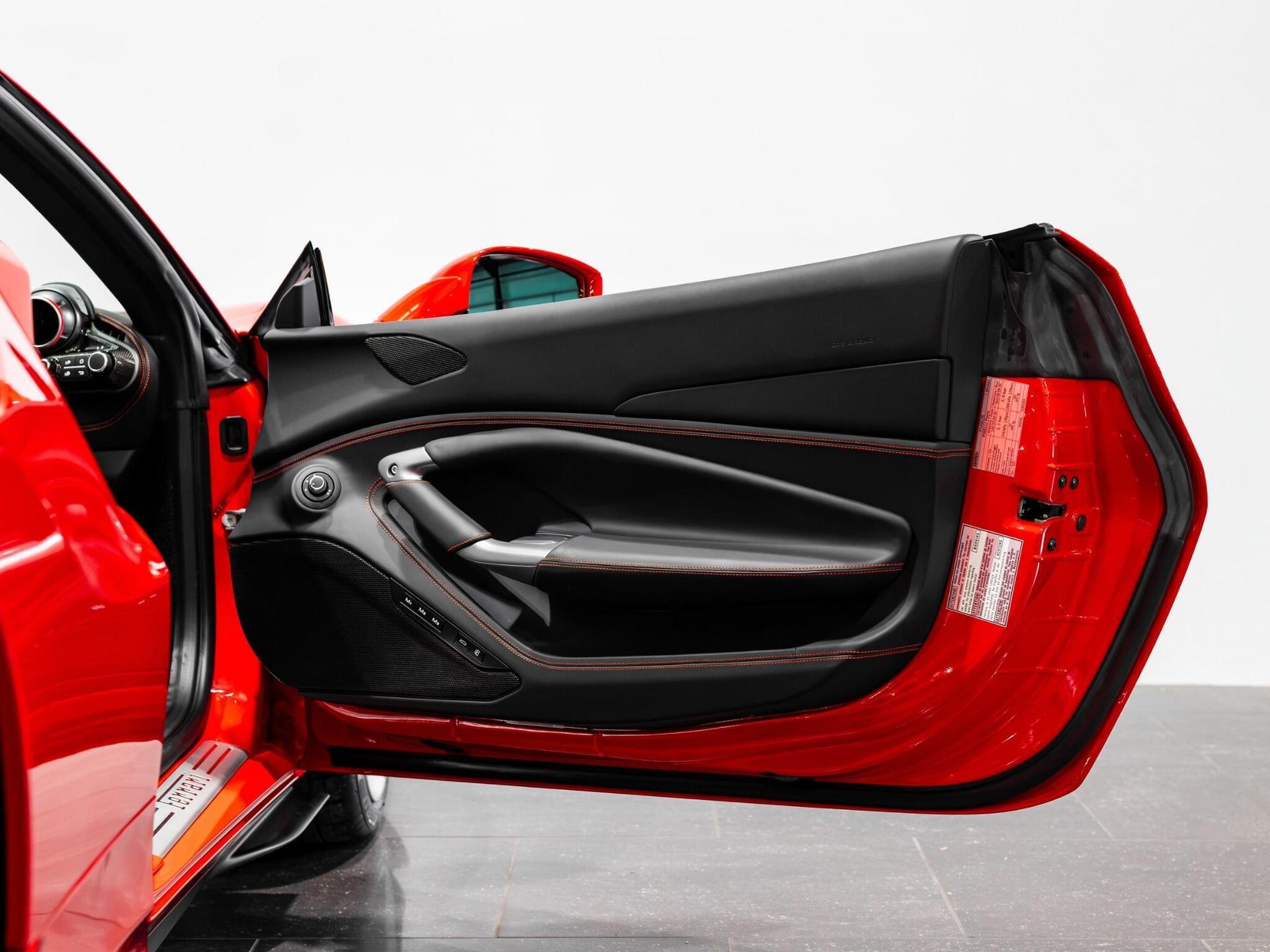 An interior shot of the door interior on a 2022 Ferrari F8 Spider