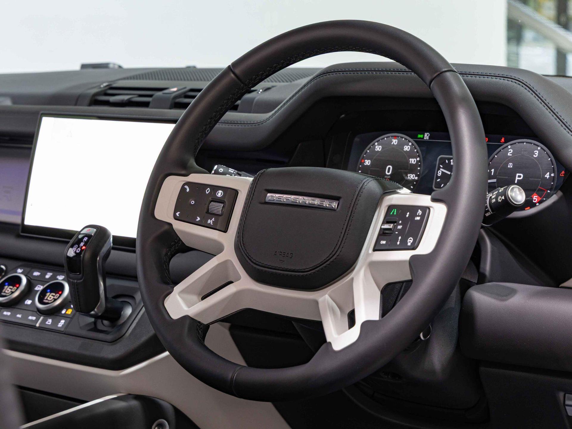 An interior shot of the steering wheel on a 2025 Land Rover Defender 90