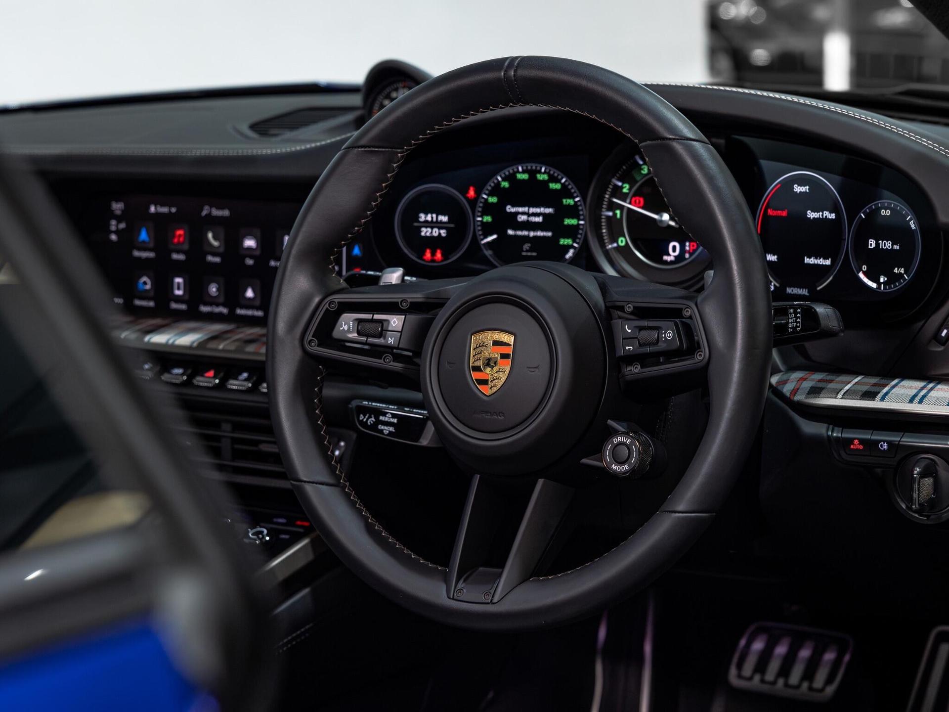 An interior shot of the steering wheel on a 2024 Porsche 911